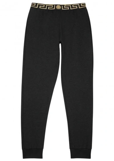 Versace Tapered Logo-jacquard Stretch-cotton Jersey Sweatpants In Black