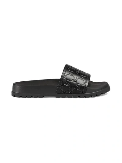 Gucci Gg Embossed Leather Slide Sandals In Black