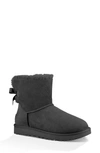 Ugg Mini Bailey Bow Ii Genuine Shearling Bootie In Black Suede