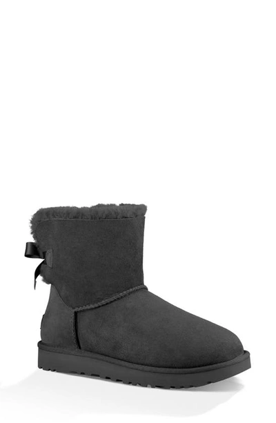 Ugg Mini Bailey Bow Ii Genuine Shearling Bootie In Black Suede