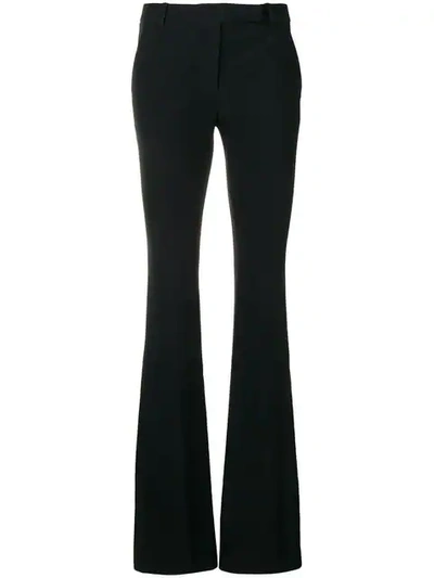 Alexander Mcqueen Tailored Wool Trousers Featuring Flared Hem In Black