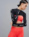 IVY PARK ACTIVE LOGO LONG SLEEVE CUTAWAY TOP IN BLACK - BLACK,29X18QBLK