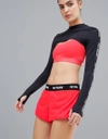 IVY PARK ACTIVE LOGO TAPED SIDE STRIPE WOVEN SHORTS IN RED - RED,29R02QFLR