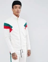 CRIMINAL DAMAGE TRACK JACKET IN WHITE WITH RED SIDE STRIPE - WHITE,CUCCIO TRACK TOP