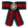 GUCCI GUCCI RED AND BLUE STRIPED RIBBON BROOCH