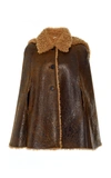 Miu Miu Sleeveless Patent Shearling Cape Jacket In Brown