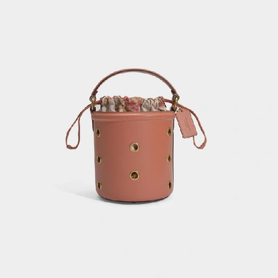 Coach Grommets Drawstring Bucket Bag In Pink Calfskin In Light Peach/brass
