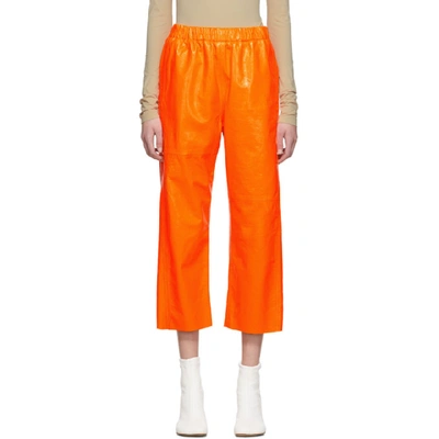 Mm6 Maison Margiela Crackled Shiny Leather Pants In Neon Orange