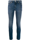 VERSACE MID RISE STUDDED SKINNY JEANS