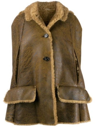 Miu Miu Sleeveless Patent Shearling Cape Jacket In Brown