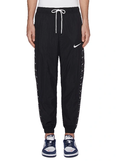 Nike Swoosh Logo Outseam Track Pants | ModeSens