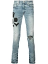 AMIRI DISTRESSED SKINNY JEANS