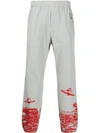 UNDERCOVER OVNI PRINT TRACK PANTS