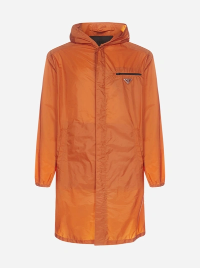 Prada Logo-plaque Nylon Piuma Hooded Raincoat In Orange