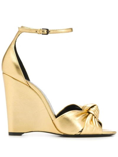 Saint Laurent Bianca Knotted Metallic Leather Wedge Sandals In Gold