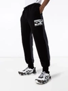 Perks And Mini X P.a.m. Logo Print Cotton Sweatpants In Black
