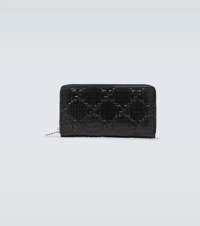 Gucci Gg Embossed Full Zipped Wallet In Black