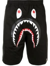 A BATHING APE GRAPHIC PRINT TRACK SHORTS