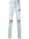 AMIRI DISTRESSED SKINNY JEANS