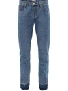 Jw Anderson Slim-fit Raw Hemmed Jeans In Blue