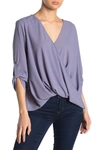 Lush Surplice Draped High/low Hem Blouse In Grey Grani