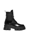 Prada Monolith Leather And Re-nylon Boots With Pouch In Nero