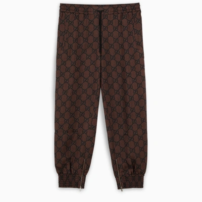Gucci Gg Supreme Print Jogging Trousers In Brown