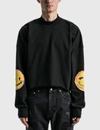 WE11 DONE BLACK SMILEY RAW EDGE SWEATSHIRT