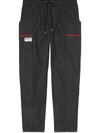 GUCCI COATED COTTON TROUSERS WITH GUCCI LABEL