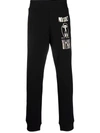 Moschino Warped Glitch Artworks Print Track Pants In Schwarz