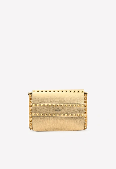 Valentino Garavani Small Rockstud Crossbody Bag In Metallic Calfskin In Gold