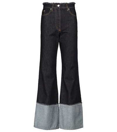 Jw Anderson Flared Raw-edge Jeans In Blue