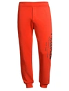 Alexander Mcqueen Graffiti Print Logo Joggers In Orange
