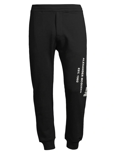 Alexander Mcqueen Graffiti Logo-print Cotton-jersey Track Pants In Black