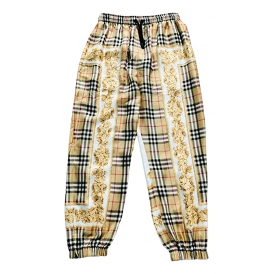 Pre-owned Burberry Silk Trousers In Yellow