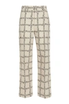 JW ANDERSON JW ANDERSON ALLOVER LOGO PRINTED TROUSERS