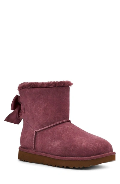 Ugg Mini Bailey Bow Glimmer Faux Fur Lined Boot In Wild Grape