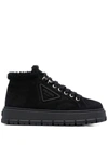 Prada Logo Plaque Shearling Ankle Boots In Schwarz
