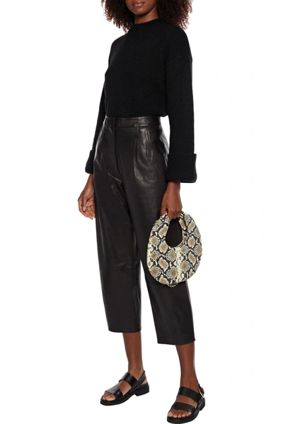 Frame Cropped Pleated Leather Tapered Trousers In Black