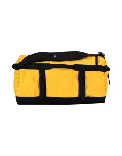 The North Face Duffel Bags In Gold
