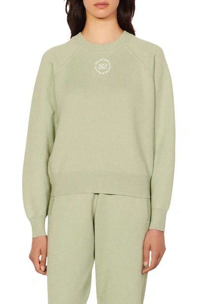 Sandro Positive Message Crewneck Sweater In Almond Green