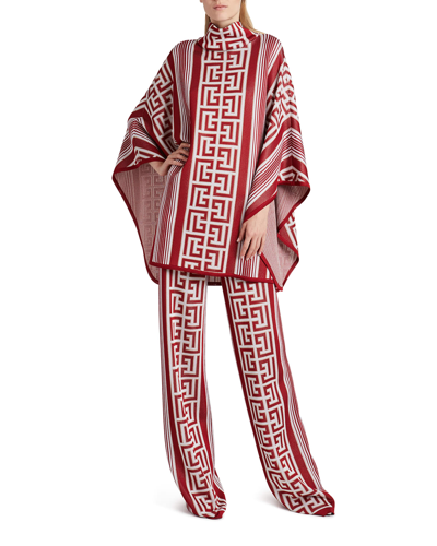 Balmain Monogram Striped Knit Poncho In Rouge Blanc