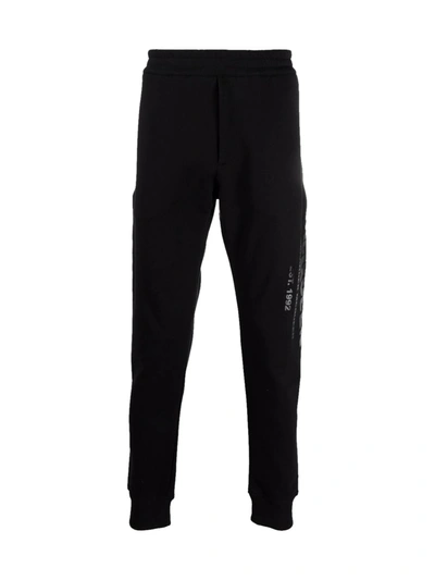 Alexander Mcqueen Graffiti-logo Cotton-jersey Track Pants In Black