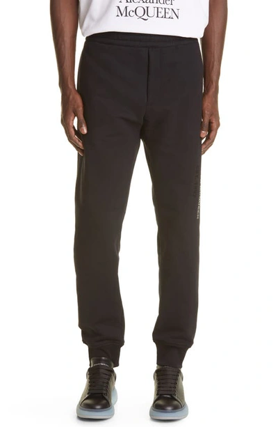 Alexander Mcqueen Graffiti-logo Cotton-jersey Track Pants In Black