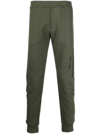 Alexander Mcqueen Logo Print Tapered Track Trousers In Grün