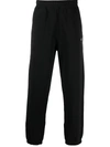 Stussy Stock Logo-print Tapered Cotton-jersey Jogging Bottoms In Black