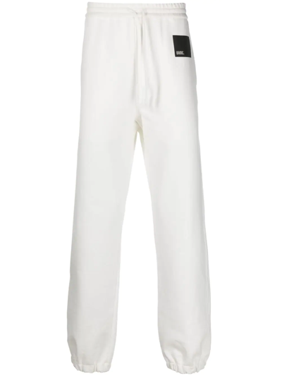 Oamc Logo-patch Cotton Track Pants In Bianco