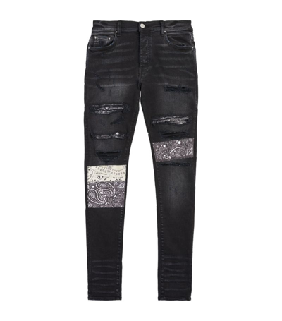 Amiri Skinny-fit Appliquéd Panelled Distressed Jeans In Black