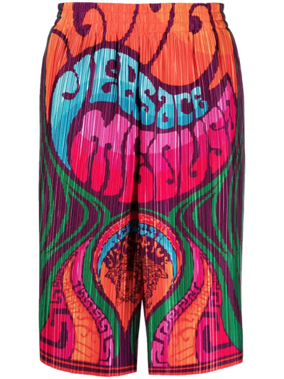 VERSACE LOGO-PRINT PLEATED SHORTS