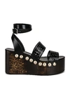 Alaïa 85mm Wooden-heel Wedge Sandals With Vienne Leather Straps And Studs In Noir